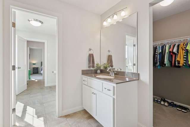 17607 64th Pl N, Maple Grove, MN 55311 - bathroom with vanity, baseboards, and a spacious closet