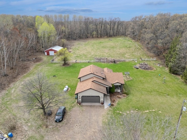 birds eye view of property featuring a view of trees and a rural view