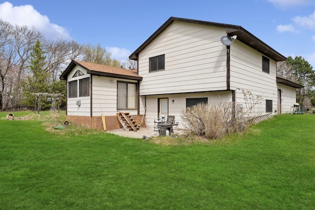 back of house with a lawn and a patio