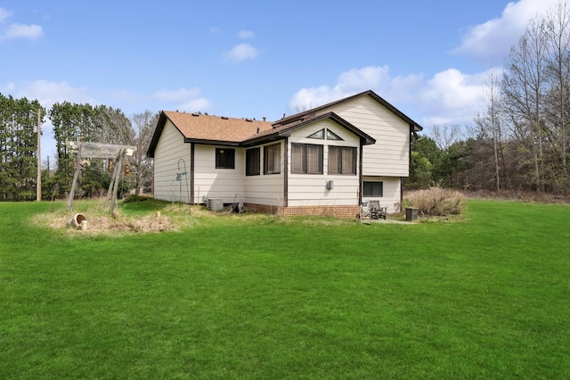 rear view of house with a lawn