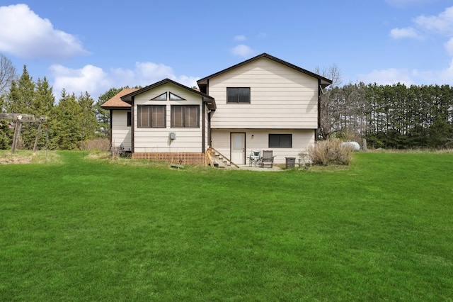 rear view of house featuring a yard