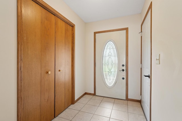 foyer entrance featuring baseboards and light tile patterned floors