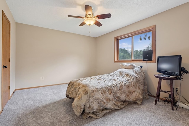 carpeted bedroom featuring baseboards and ceiling fan