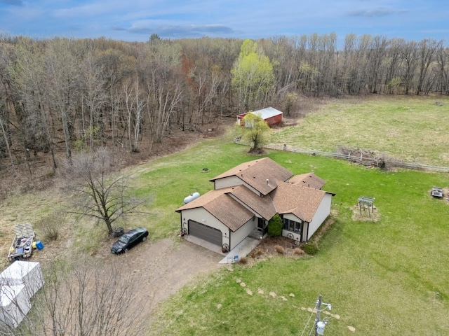 birds eye view of property with a view of trees
