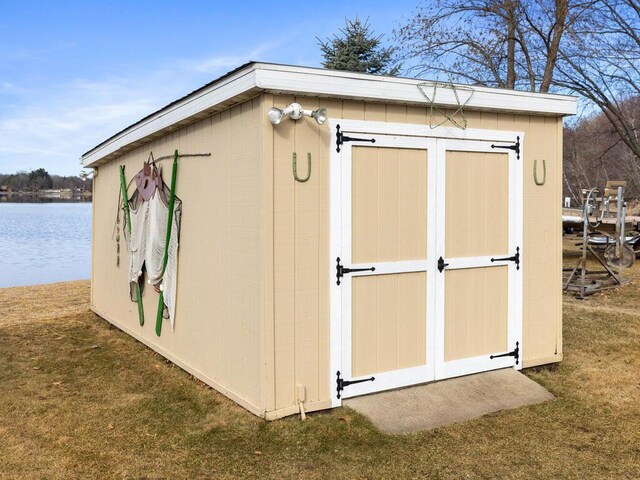 view of shed with a water view