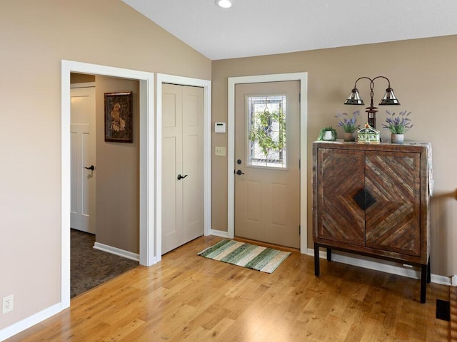 entrance foyer with light wood finished floors, baseboards, lofted ceiling, and recessed lighting
