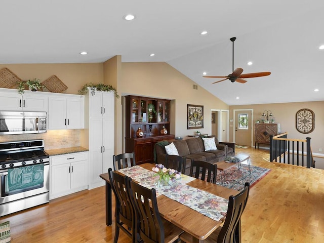 dining space with vaulted ceiling, a ceiling fan, light wood-style flooring, and recessed lighting