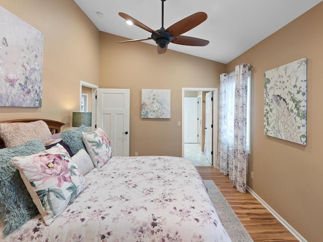 bedroom featuring light wood-style floors, baseboards, ceiling fan, and high vaulted ceiling