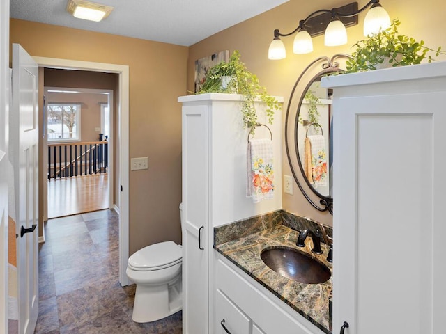 bathroom featuring toilet and vanity