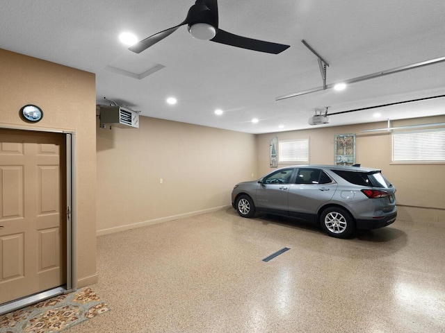garage featuring a garage door opener, baseboards, ceiling fan, and recessed lighting