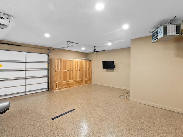 garage featuring recessed lighting, baseboards, and a garage door opener