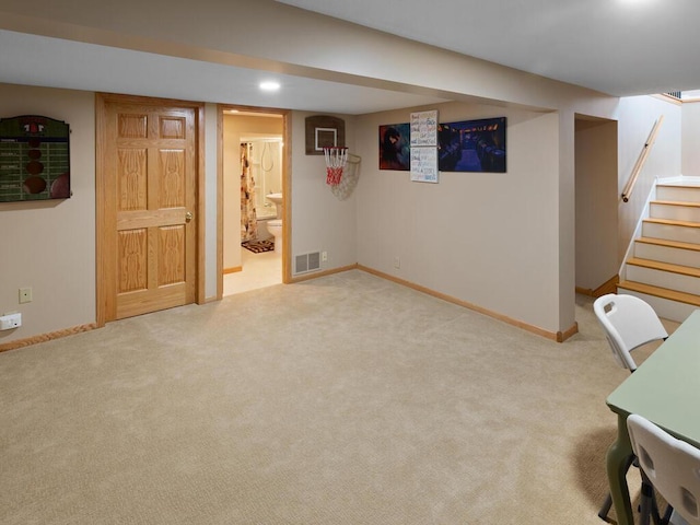 finished below grade area with carpet, stairway, baseboards, and recessed lighting