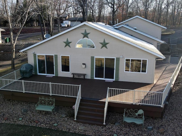 rear view of property with a wooden deck