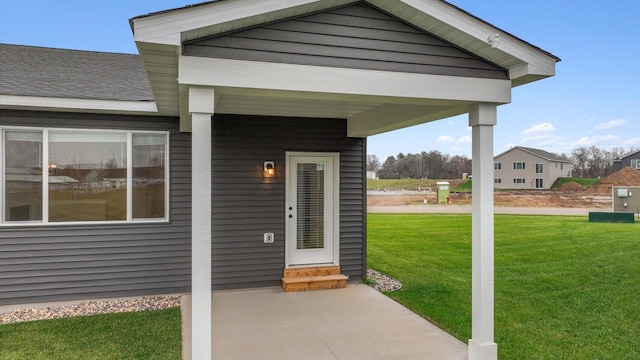 entrance to property with a lawn