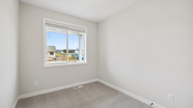 spare room featuring visible vents, baseboards, and carpet