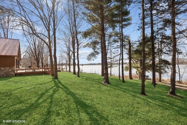 view of yard featuring a deck with water view