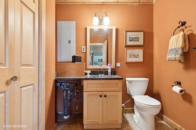 bathroom featuring baseboards, electric panel, toilet, vanity, and tile patterned flooring