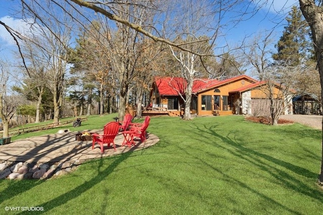 view of yard featuring a fire pit and an attached garage