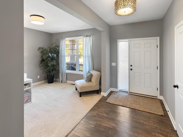 entryway featuring baseboards and hardwood / wood-style floors