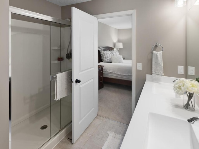 full bathroom featuring a shower stall, ensuite bath, vanity, and tile patterned floors
