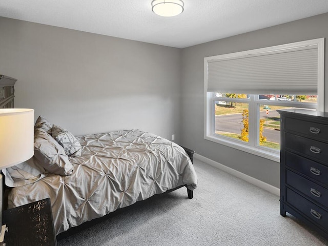 bedroom featuring baseboards and carpet flooring