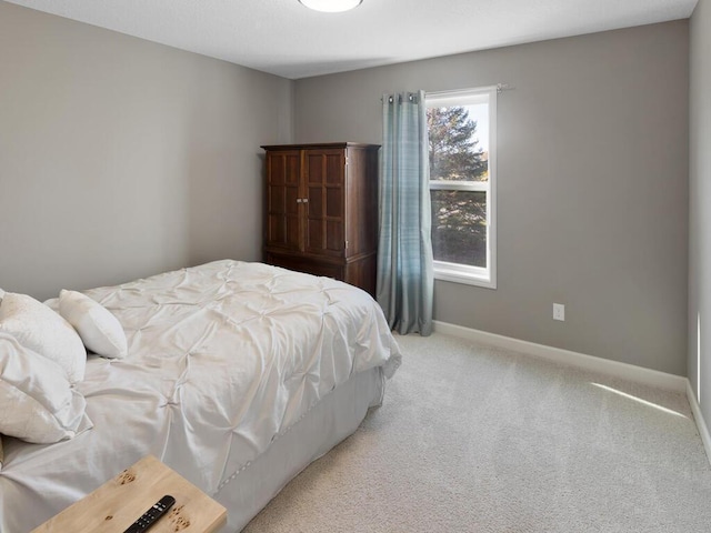 carpeted bedroom with baseboards