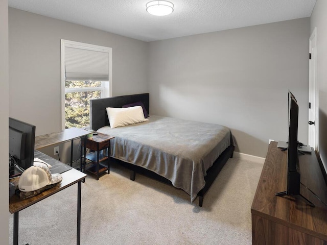 carpeted bedroom featuring a textured ceiling
