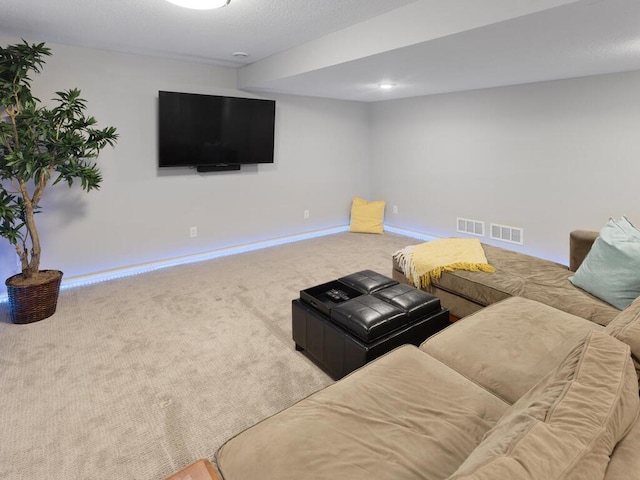 carpeted living area featuring baseboards and visible vents