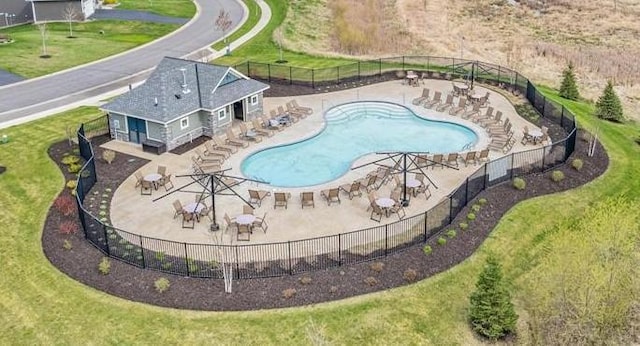 community pool featuring a patio area and fence
