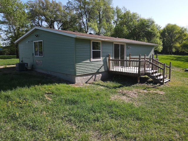 482 US Highway 12, Ortonville, MN 56278 - back of property with a wooden deck, a yard, and central AC