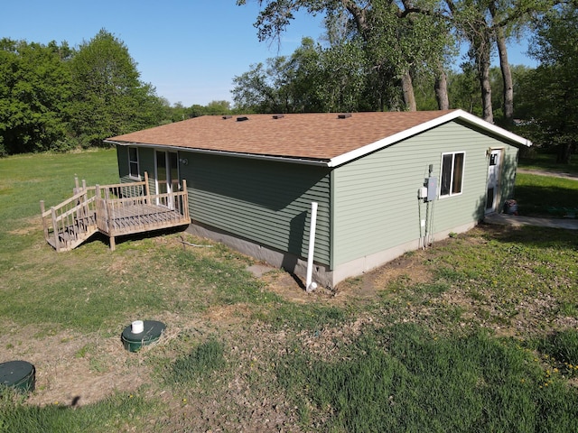 482 US Highway 12, Ortonville, MN 56278 - view of side of home featuring a wooden deck, a lawn, and roof with shingles