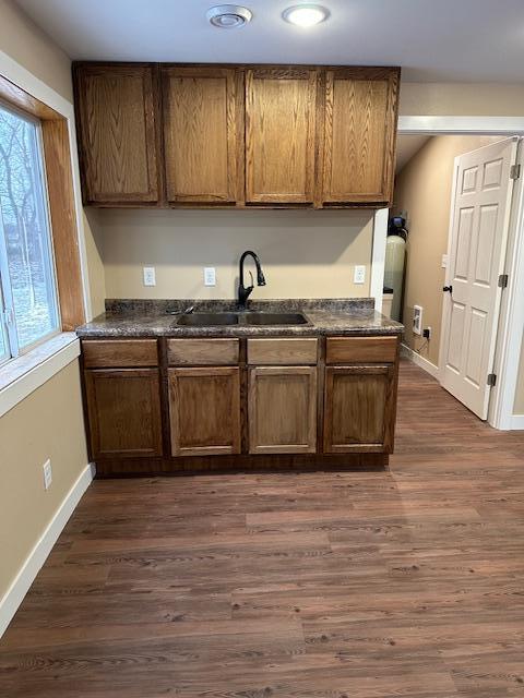 482 US Highway 12, Ortonville, MN 56278 - kitchen with a sink, dark countertops, baseboards, dark wood-type flooring, and recessed lighting
