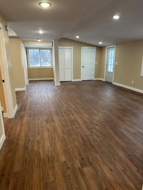 482 US Highway 12, Ortonville, MN 56278 - unfurnished room with baseboards, vaulted ceiling, dark wood-style flooring, healthy amount of natural light, and recessed lighting