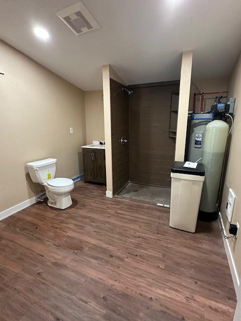 482 US Highway 12, Ortonville, MN 56278 - bathroom with a shower stall, wood finished floors, toilet, and baseboards