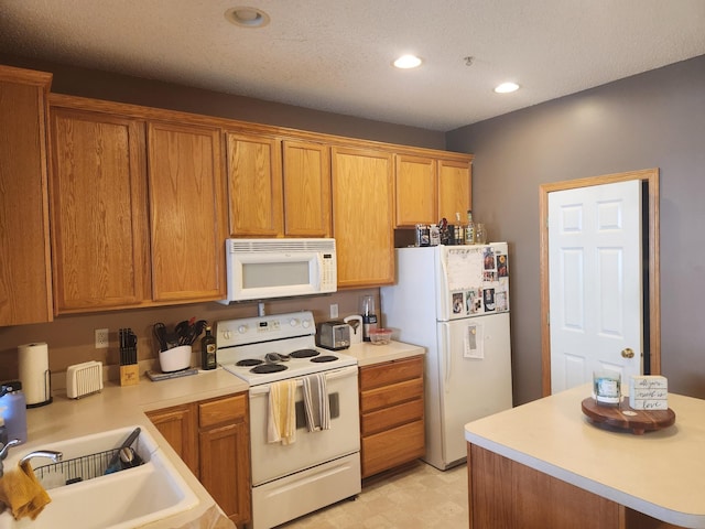 14494 Sumter Ave, Savage, MN 55378 - kitchen featuring white appliances, light countertops, a sink, light flooring, and recessed lighting