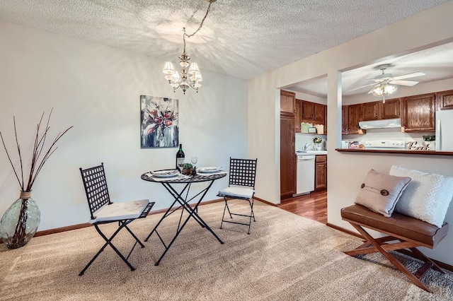 10600 43rd Ave N Unit 205, Plymouth, MN 55442 - dining area featuring ceiling fan with notable chandelier, carpet flooring, and a textured ceiling