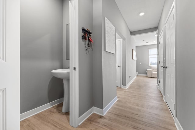 12678 Erskin St NE, Blaine, MN 55449 - hallway featuring light wood finished floors, baseboards, and recessed lighting