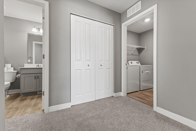 12678 Erskin St NE, Blaine, MN 55449 - laundry room with carpet floors, washing machine and clothes dryer, and baseboards