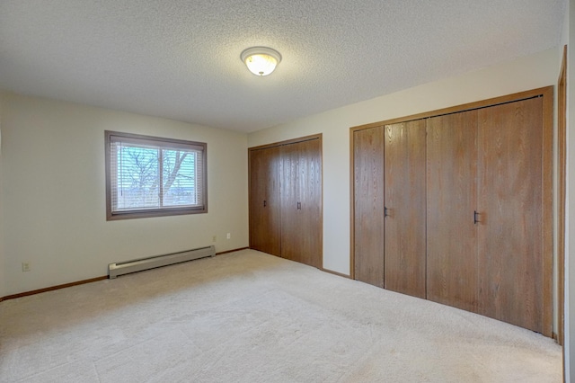 14831 Endicott Way Unit 315, Apple Valley, MN 55124 - unfurnished bedroom with baseboards, a textured ceiling, multiple closets, carpet, and a baseboard radiator