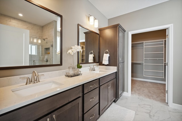 19995 Hunters Rdg, Corcoran, MN 55374 - full bathroom with marble finish flooring, a shower stall, a walk in closet, baseboards, and double vanity