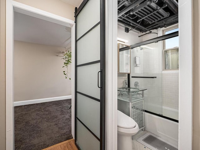 4136 Queen Ave S Unit 108, Minneapolis, MN 55410 - bathroom featuring toilet, a sink, and bath / shower combo with glass door