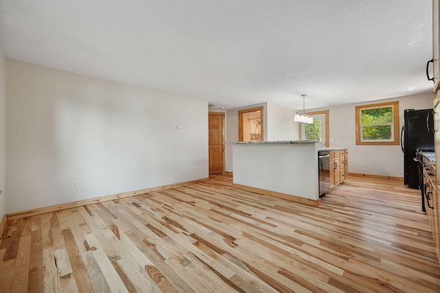 4963 Crofoot Ave NW, Buffalo, MN 55313 - unfurnished living room with light wood finished floors and a chandelier