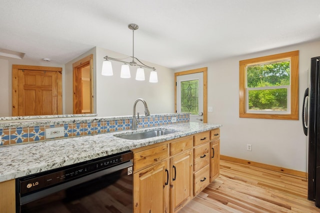 4963 Crofoot Ave NW, Buffalo, MN 55313 - kitchen featuring black appliances, light wood-style flooring, light stone countertops, hanging light fixtures, and backsplash