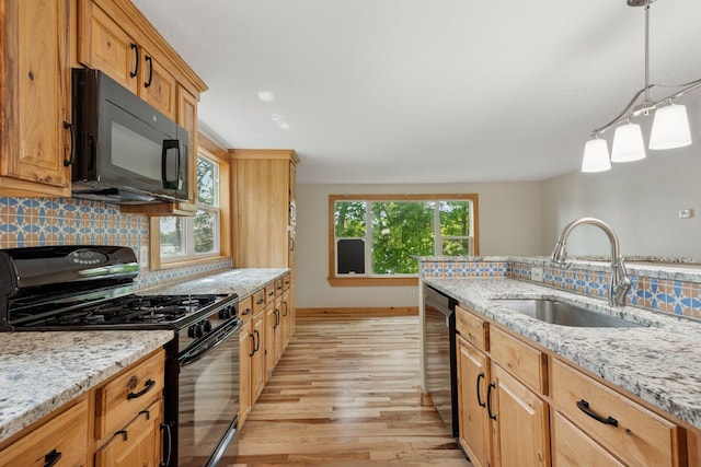 4963 Crofoot Ave NW, Buffalo, MN 55313 - kitchen with black appliances, light wood finished floors, decorative backsplash, and light stone countertops