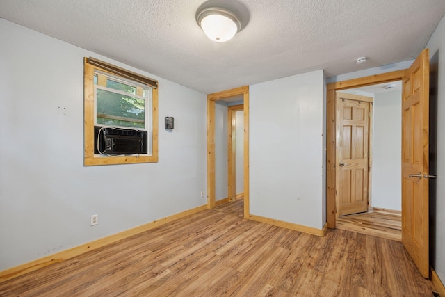 4963 Crofoot Ave NW, Buffalo, MN 55313 - unfurnished room with wood finished floors, cooling unit, a textured ceiling, and a smoke detector