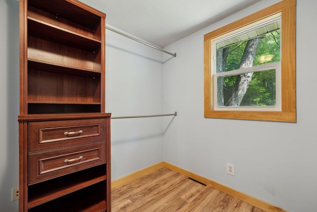 4963 Crofoot Ave NW, Buffalo, MN 55313 - walk in closet with light wood-type flooring