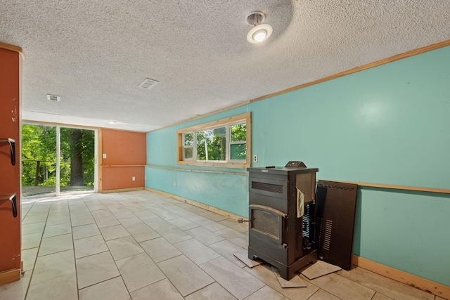 4963 Crofoot Ave NW, Buffalo, MN 55313 - spare room with a wood stove and a textured ceiling