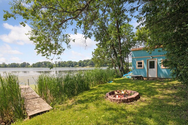 4963 Crofoot Ave NW, Buffalo, MN 55313 - view of grassy yard with a water view, a fire pit, and an outbuilding