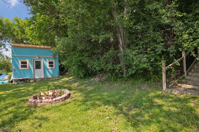 4963 Crofoot Ave NW, Buffalo, MN 55313 - view of green lawn featuring an outdoor fire pit and a storage unit