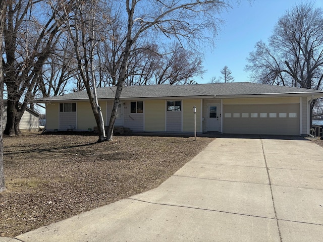single story home with an attached garage and concrete driveway